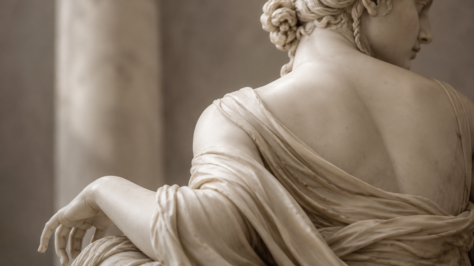 Classical sculpture of a goddess figure with flowing drapery, photographed in soft museum lighting